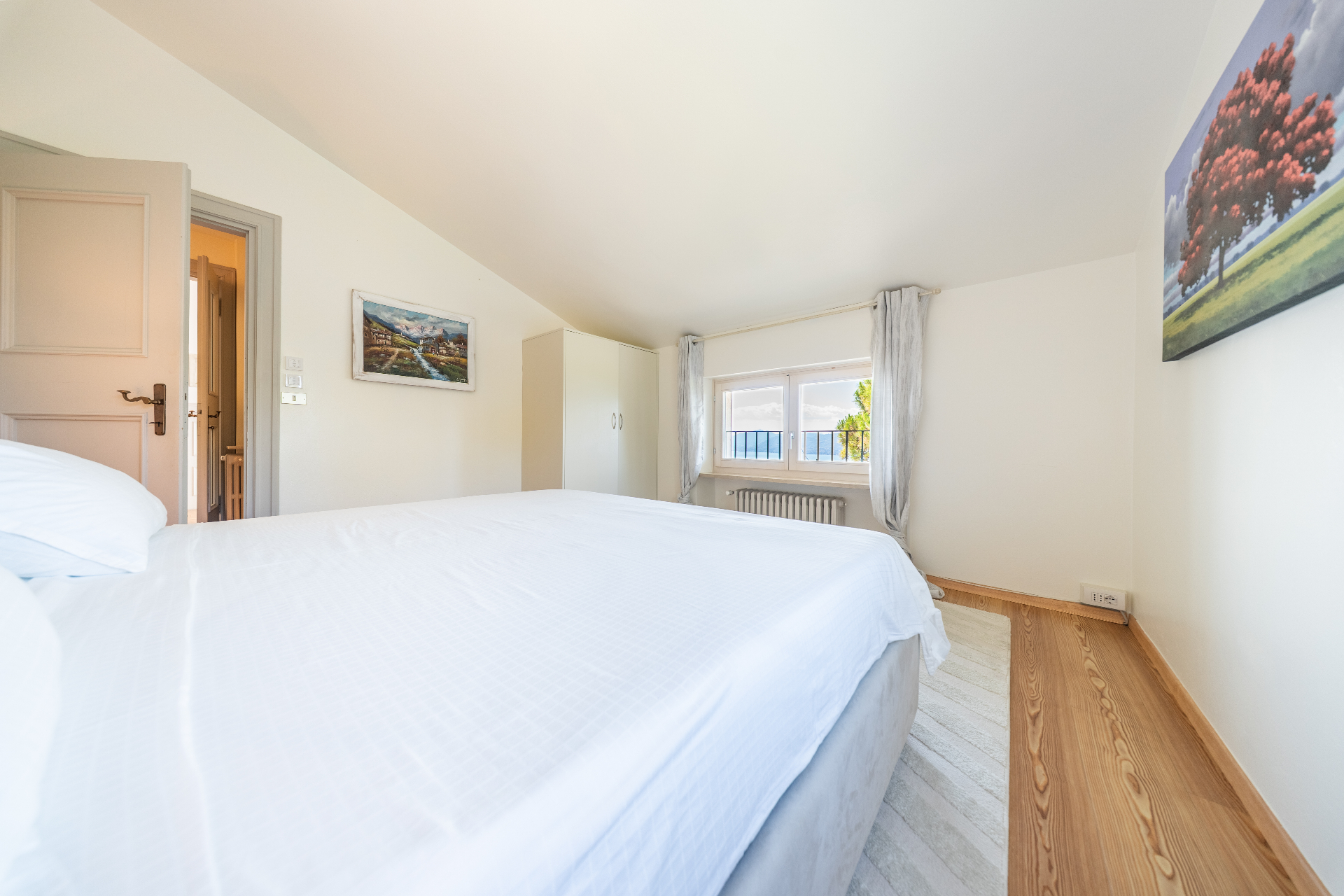 Attic bedroom with lake-view window and pitched ceiling